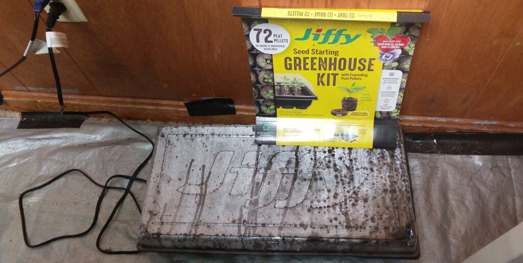 My Jiffy Seed Starting Greenhouse Kit with 72 peat pellets germinating on a seed starting heat mat